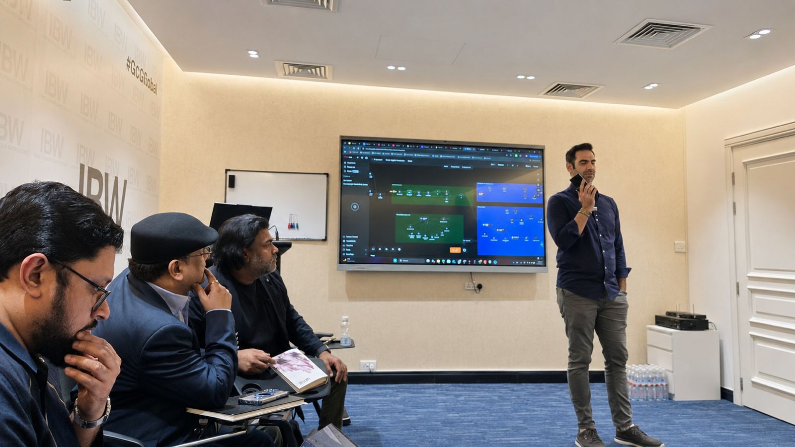 Sam Fouladgar presenting an AI agentic workflow for sales outreach automation on screen to AI Mavericks community members at the IBW Center of Excellence, Doha.