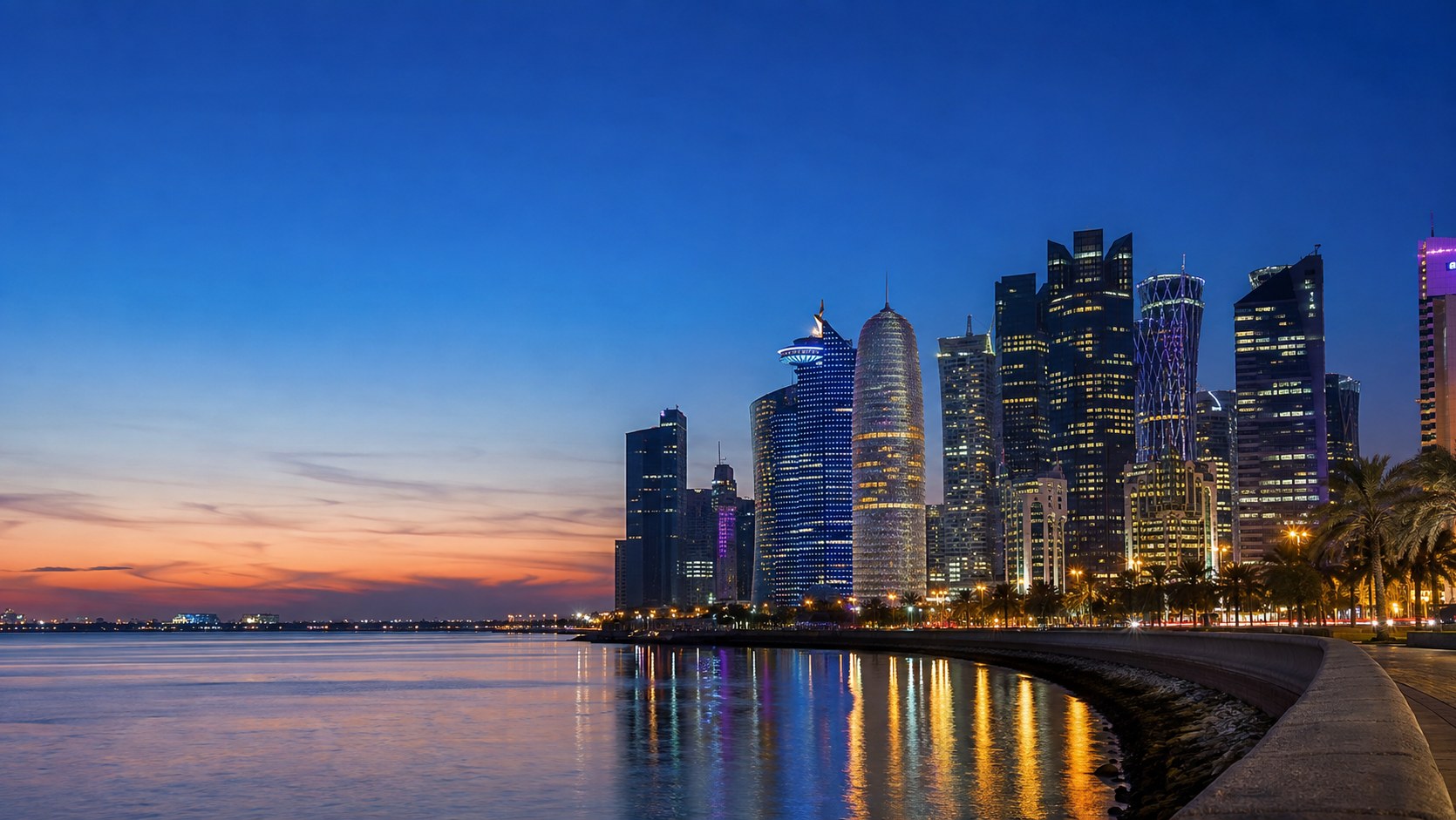 The Doha West Bay skyline at night reflected in the Corniche waterfront