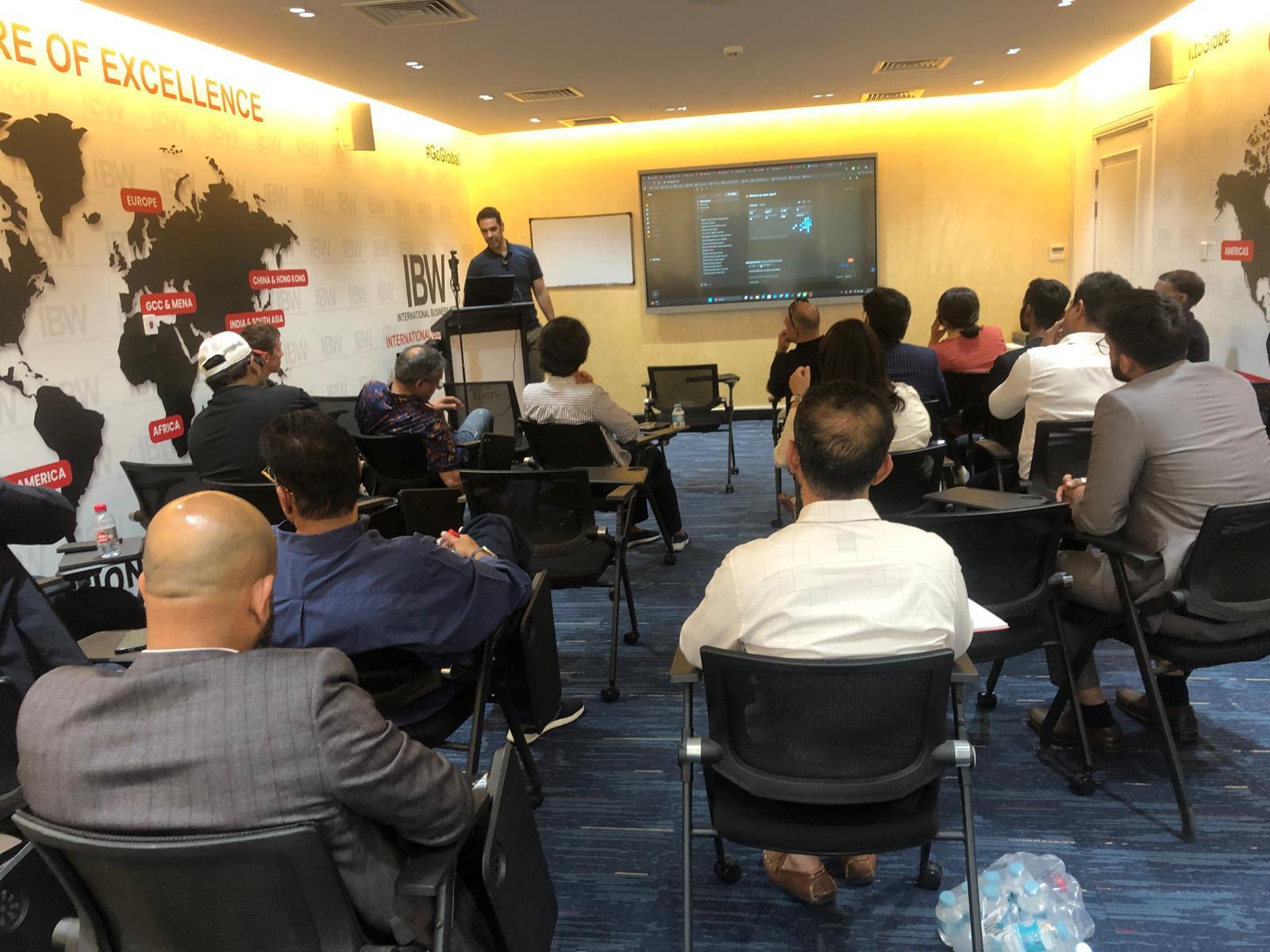 Audience and speaker at an AI Mavericks session in Doha.