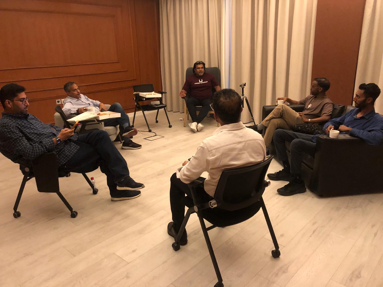 AI Mavericks members in a small-group roundtable conversation.